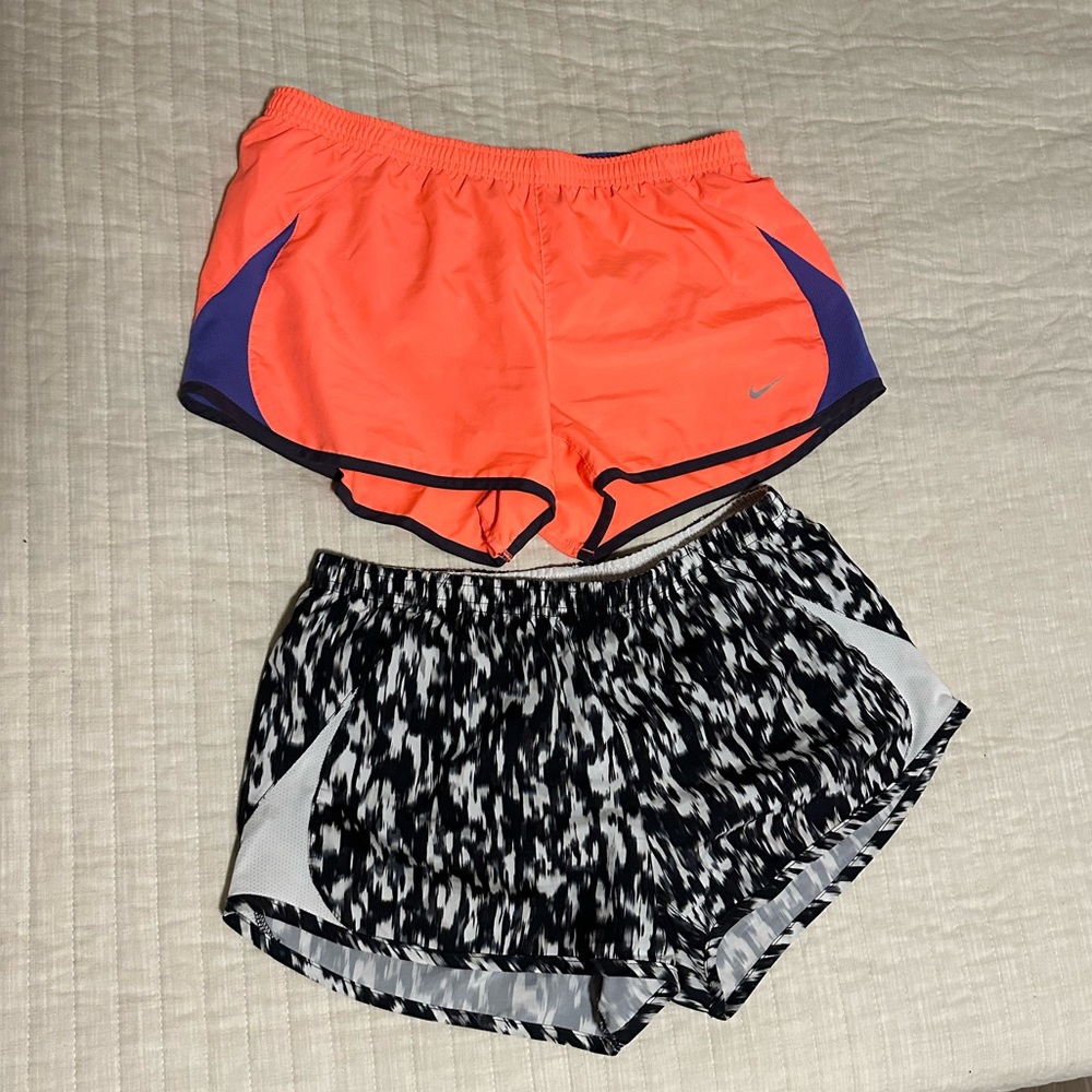 Two pairs women medium Nike running shorts